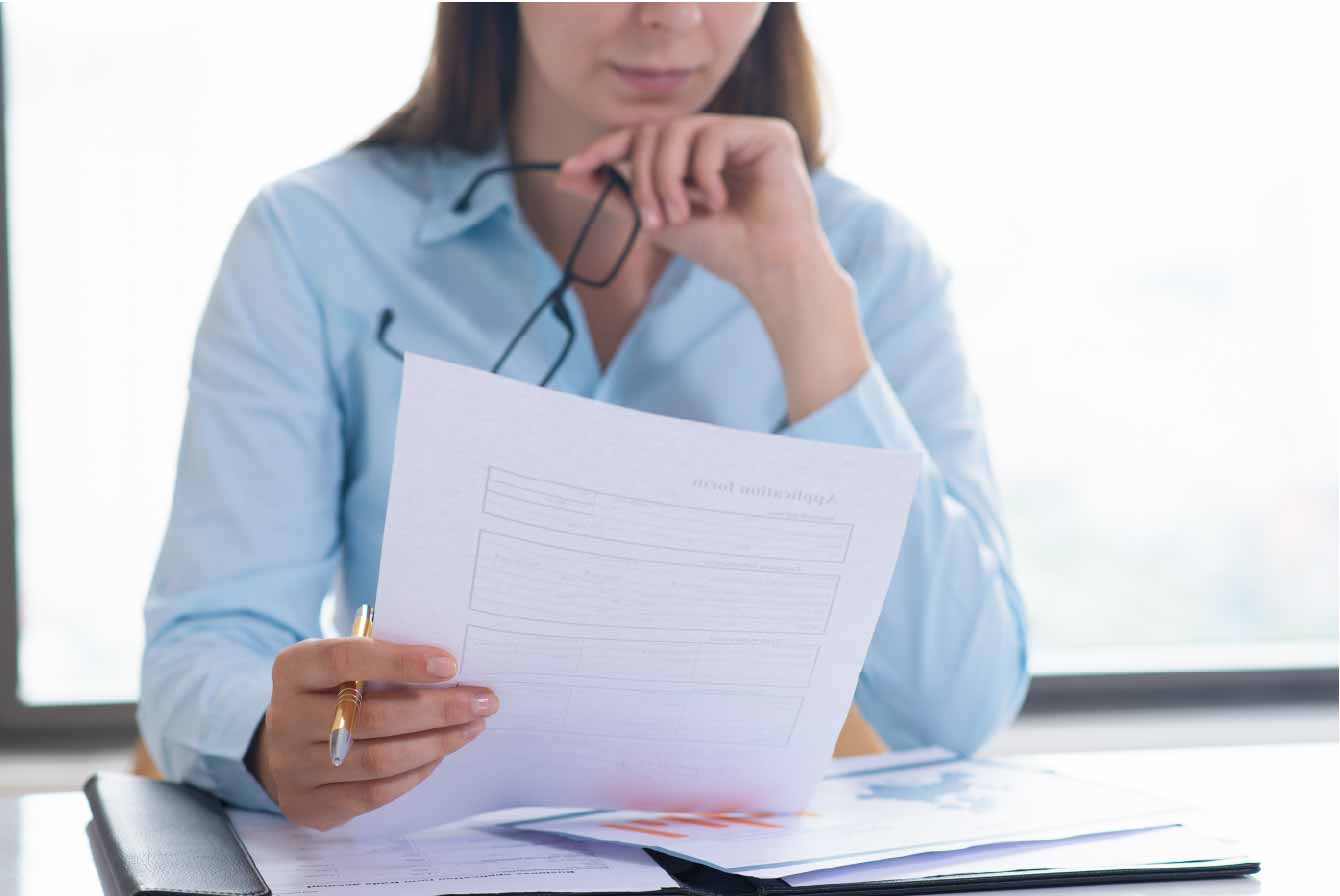 3.1 closeup-woman-holding-reading-document-01 3.1 closeup-woman-holding-reading-document-01